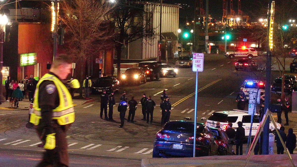 Tacoma police and other law enforcement vehicles are shown near the site of a car crash Saturday, Jan. 23, 2021, in downtown Tacoma, Wash. (Associated Press)