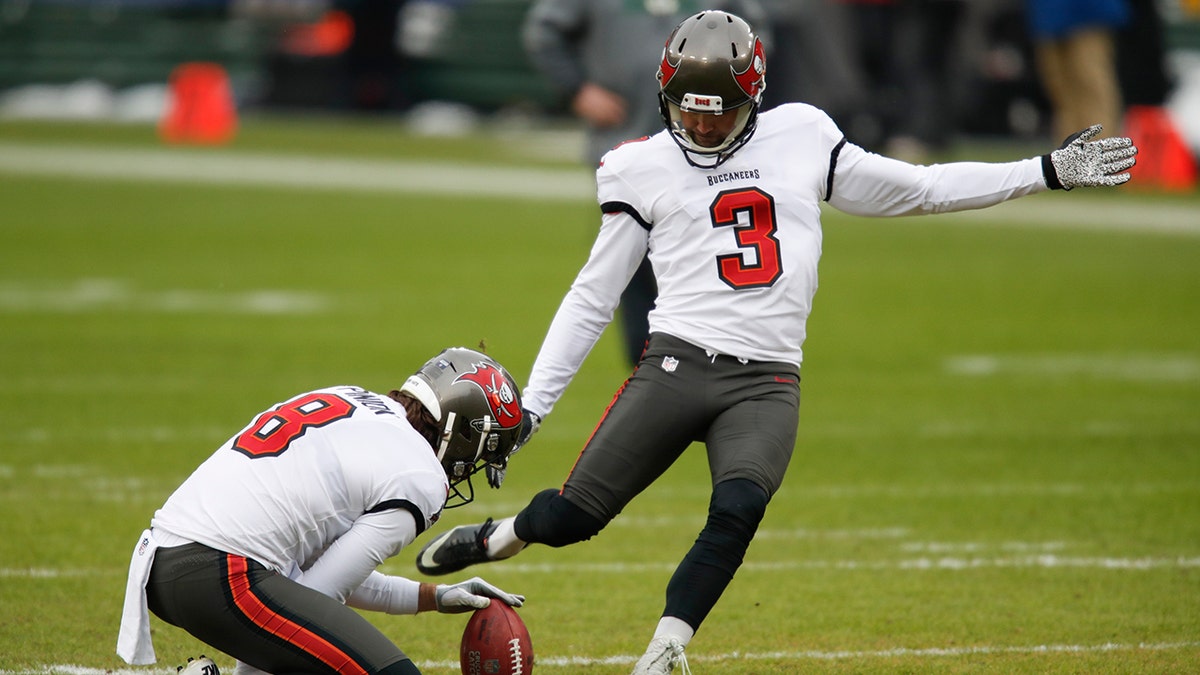 Tampa Bay Buccaneers kicker Ryan Succop warms up with Bradley Pinion (8) before the NFC championship NFL football game against the Green Bay Packers in Green Bay, Wis., Sunday, Jan. 24, 2021. (AP Photo/Matt Ludtke)