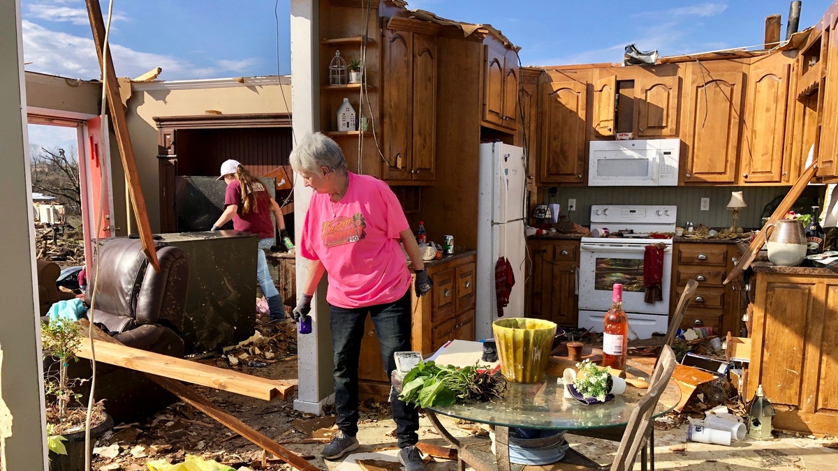 Patti Herring sobs as she sorts through the remains of her home in Fultondale, Ala., on Tuesday, Jan. 26, 2021, after it was destroyed by a tornado. (AP Photo/Jay Reeves)