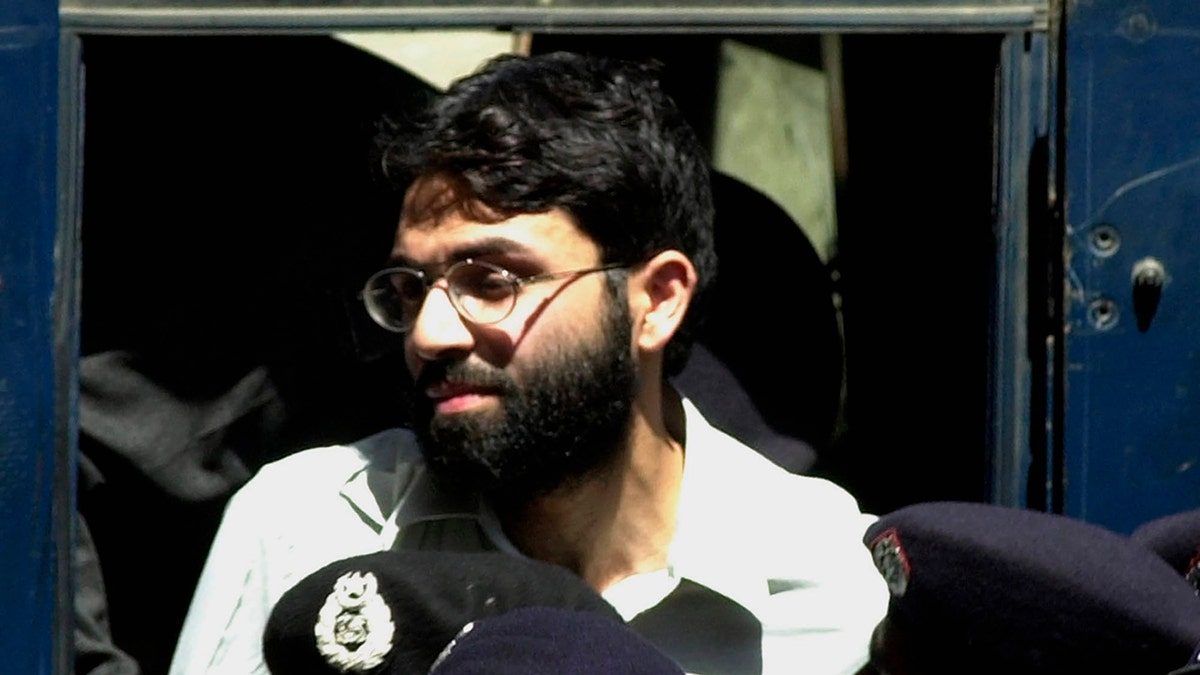 FILE - In this March 29, 2002 file photo, Ahmed Omar Saeed Sheikh, a British-Pakistani man accused in the 2002 killing of the American Wall Street Journal reporter Daniel Pearl appears at the court in Karachi, Pakistan. In a dramatic turn of events, Sheikh, a man convicted and later acquitted in the 2002 murder of Pearl admitted a "minor" role in his death, upending 18 years of denials, the Pearl family lawyer said Wednesday, Jan. 27, 2021. (AP Photo/Zia Mazhar, File)