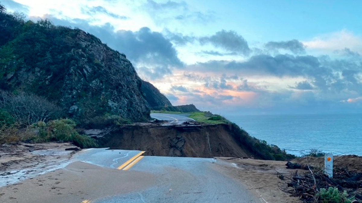 In this photo provided by Caltrans, a section of Highway 1 is collapsed following a heavy rainstorm near Big Sur, Calif., on Friday, Jan. 29, 2021. A drenching storm that brought California much-needed rain in what had been a dry winter wound down Friday after washing out Highway 1 near Big Sur, burying the Sierra Nevada in snow and causing muddy flows from slopes burned bare by wildfires. (Caltrans via AP)