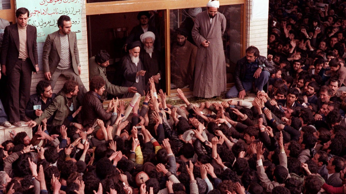 The late Ayatollah Ruhollah Khomeini, center, is greeted by supporters after arriving at the airport in Tehran Iran in this Feb. 1, 1979 photo. ( AP Photo )