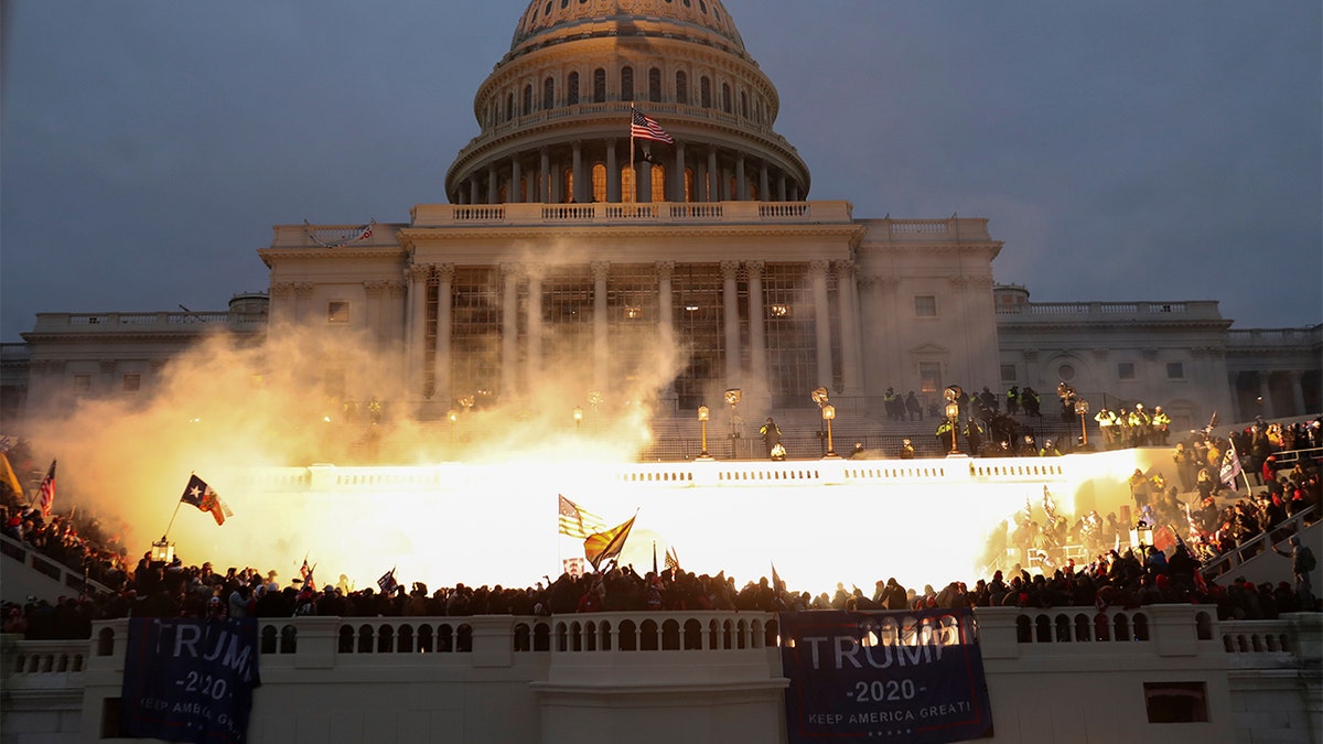 An explosion caused by a police munition is seen while supporters of U.S. President Donald Trump gather in front of the U.S. Capitol Building in Washington, D.C., Jan. 6, 2021.