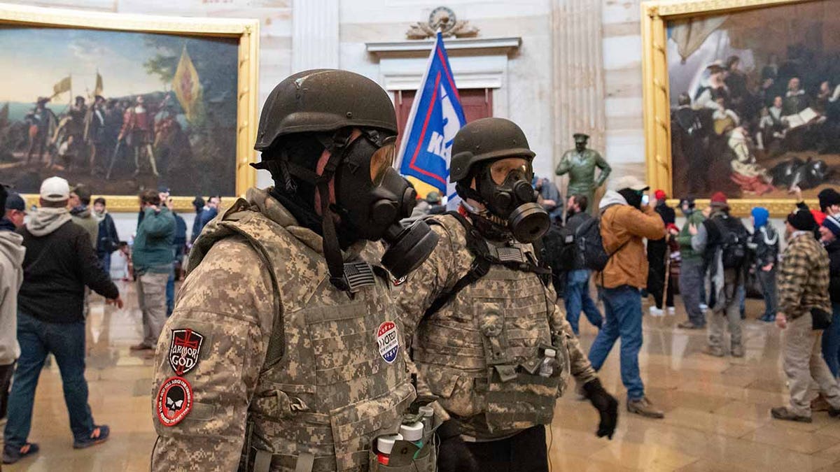 Supporters of President Trump wear gas masks and military-style apparel as they walk around inside the Rotunda after breaching the US Capitol in Washington, D.C., on Jan. 6, 2021.?