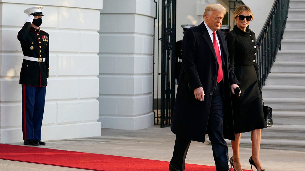 President Donald Trump and first lady Melania Trump walk to board Marine One on the South Lawn of the White House, Wednesday, Jan. 20, 2021, in Washington. Trump is en route to his Mar-a-Lago Florida Resort. (AP Photo/Alex Brandon)