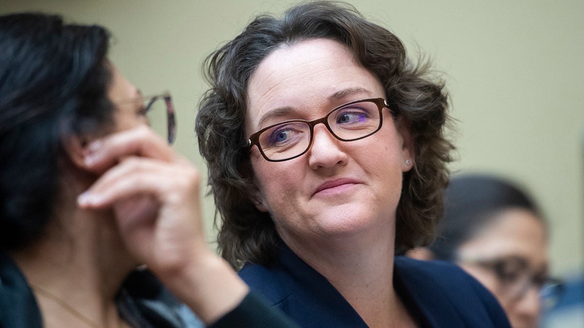 Reps. Katie Porter, D-Calif., center, smiling