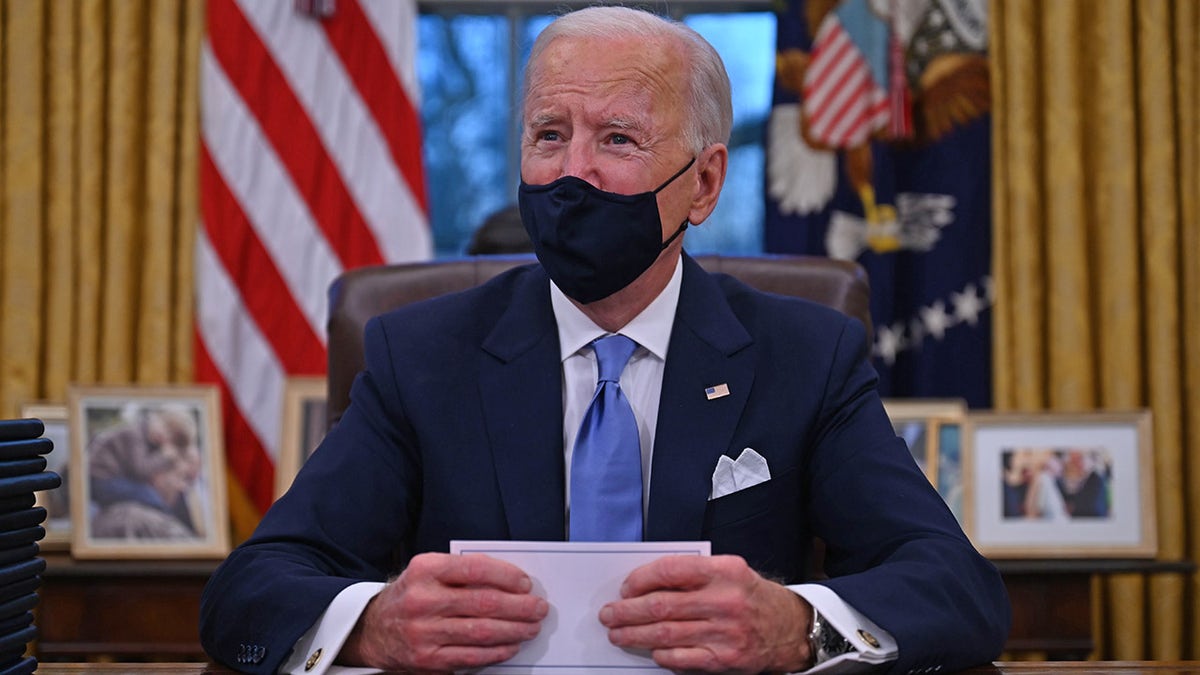 US President Joe Biden prepares to sign a series of orders in the Oval Office of the White House in Washington, DC, after being sworn in at the US Capitol on January 20, 2021. The party leaders in the Senate are struggling to come to a power-sharing agreement, something that could handicap its ability to handle Biden's agenda if not handled quickly. (Photo by Jim WATSON / AFP) (Photo by JIM WATSON/AFP via Getty Images)