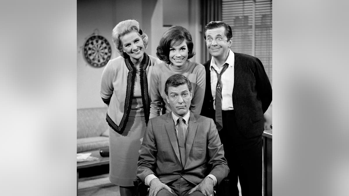 'The Dick Van Dyke Show' cast:?<br>
?Standing, left to right: Rose Marie, Mary Tyler Moore, Morey Amsterdam; (seated) Dick Van Dyke. Image dated 1961.