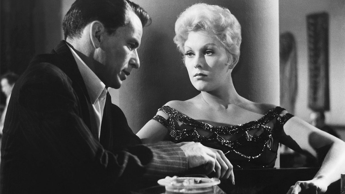 American actors Frank Sinatra and Kim Novak on the set of 'The Man with the Golden Arm,' directed by Austro–Hungarian-American Otto Preminger.