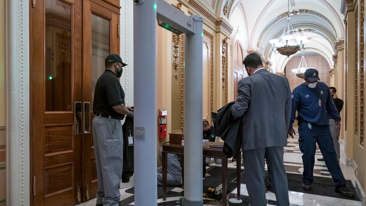 Metal detectors for lawmakers are installed in the corridor around the House of Representatives chamber after a mob loyal to President Donald Trump stormed the Capitol last week, in Washington, Tuesday, Jan. 12, 2021.