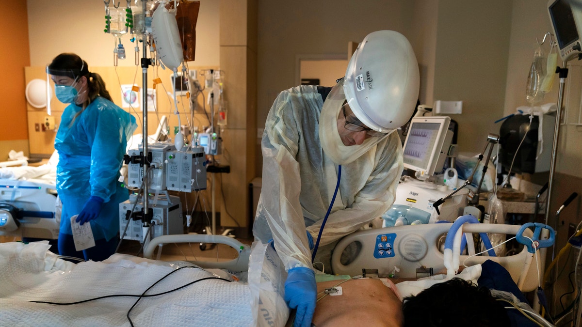 In this Nov. 19, 2020, file photo, Dr. Rafik Abdou checks on a COVID-19 patient at Providence Holy Cross Medical Center in the Mission Hills section of Los Angeles. 