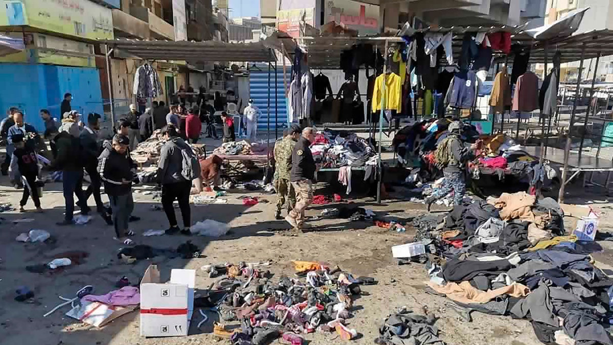 <br>
People and security forces gather at the site of a deadly bomb attack in a market selling used clothes, in Baghdad, Iraq, Jan. 21, 2021. (Associated Press)