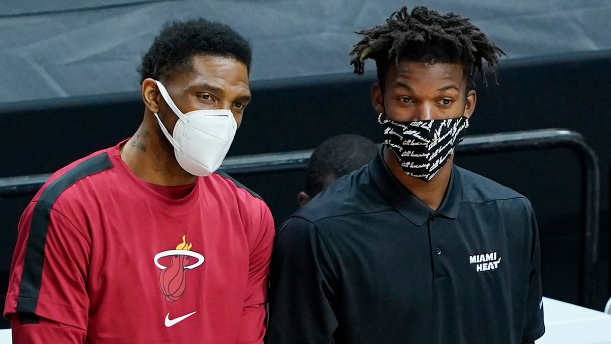 Miami Heat players Udonis Haslem, left, talks to Jimmy Butler during the first half of an NBA basketball game against the Denver Nuggets, Wednesday, Jan. 27, 2021, in Miami.