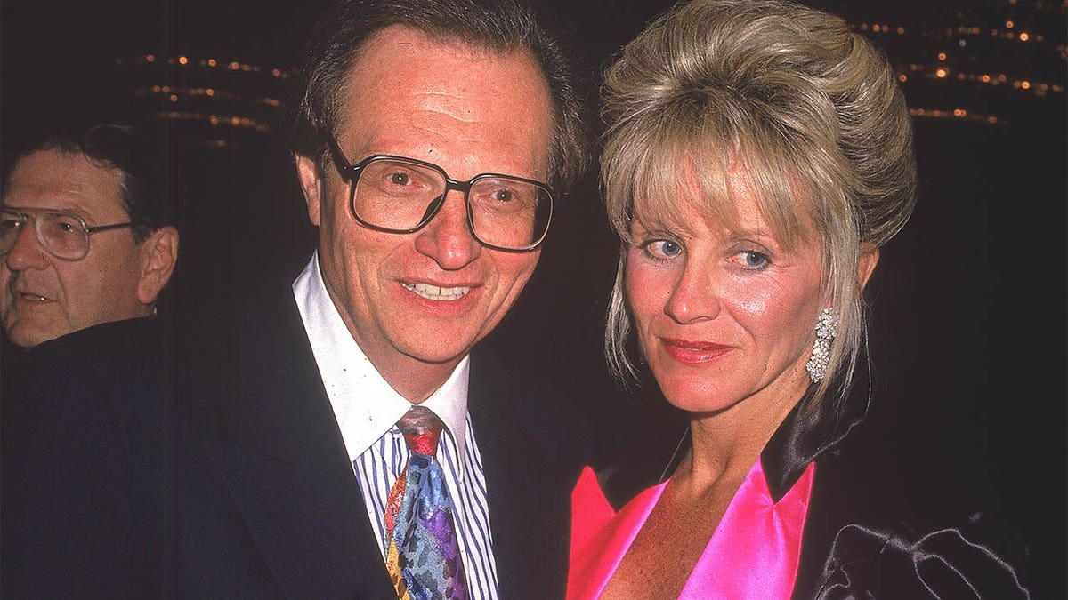 Circa 1990, American talk show host Larry King with his sixth wife, Julie Alexander. They divorced in 1992. 