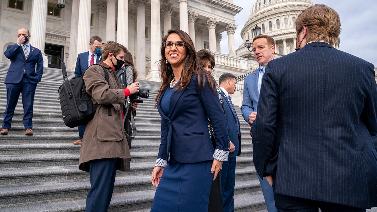 Rep. Lauren Boebert, R-Colo., center, smiles after joining other freshman Republican House members for a group photo at the Capitol in Washington, Jan. 4, 2021. (AP Photo/J. Scott Applewhite)