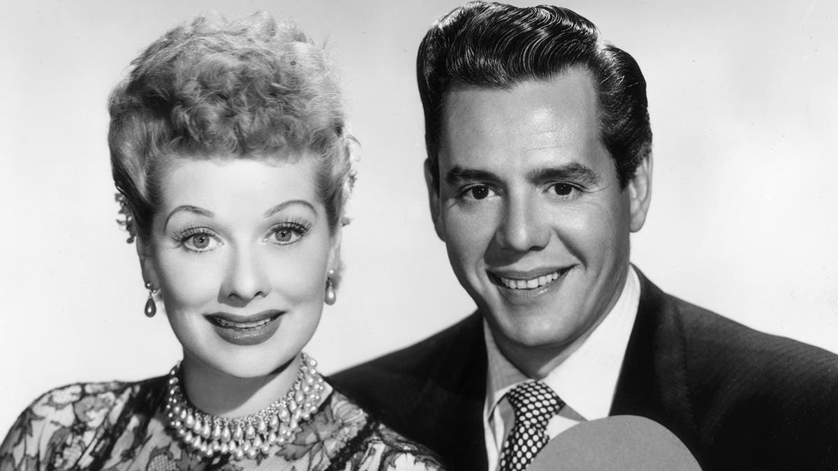 circa 1955:  Portrait of American actor and comedian Lucille Ball (1911-1989) and her husband, Cuban-born actor and bandleader Desi Arnaz (1917-1986), holding heart-shaped cutouts.  (Photo by CBS Photo Archive/Getty Images)