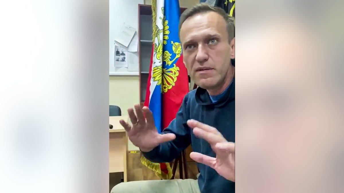 In this image taken from video released by Kira Yarmysh on her Twitter account, Russian opposition leader Alexei Navalny gestures as he waits for a court hearing in a police station in Khimki, outside in Moscow, Russia, Monday, Jan. 18, 2021. Russian opposition leader Alexei Navalny's arrest as he arrived in Moscow after recovering from his poisoning with a nerve agent has drawn widespread criticism from Western nations.