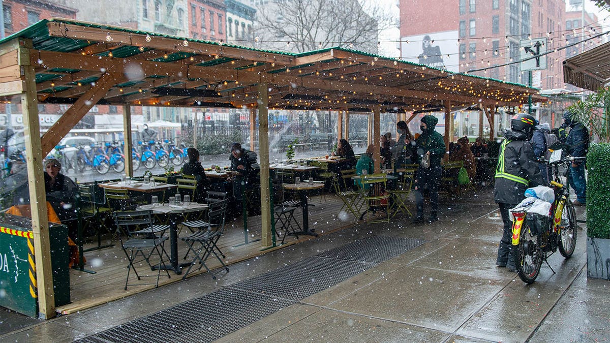 Customers dine outdoors at Jack's Wife Freda's enclosed outdoor dining structure during a snowstorm amid the coronavirus pandemic in SoHo on Jan. 26, 2021, in New York City. The pandemic continues to burden restaurants and bars as businesses struggle to thrive with evolving government restrictions and social distancing plans made harder by inclement weather. (Alexi Rosenfeld/Getty Images)