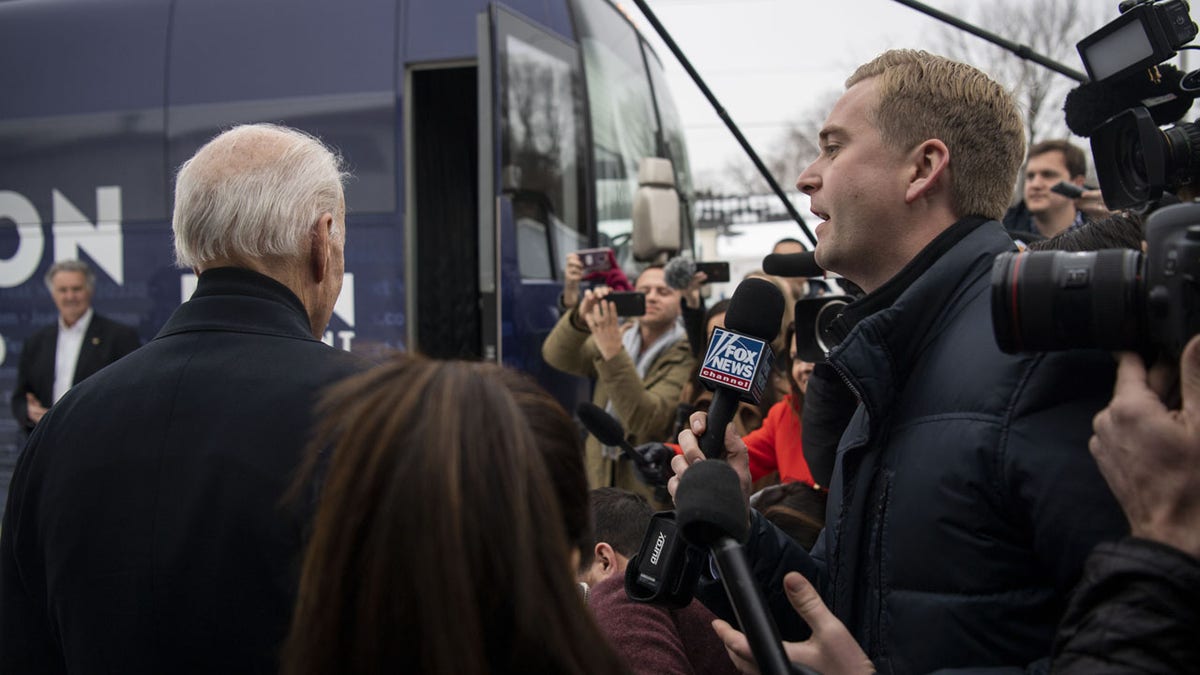 Peter Doocy, a Fox News reporter, tries to ask former vice president Joe Biden a question, which is ignored, as Biden exits a campaign event at Jeno's Little Hungary in Davenport, Iowa, on Jan. 28, 2020. 