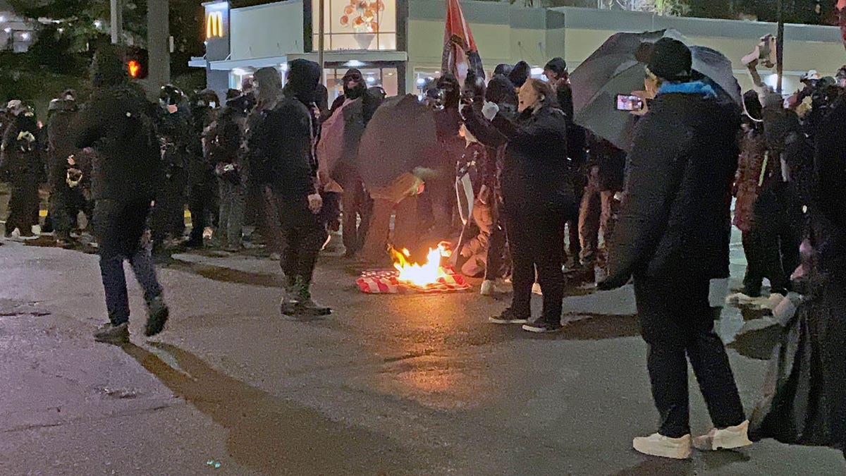 After Tacoma Police set up a police line, the Antifa activists stopped their march to set fire to an American flag.