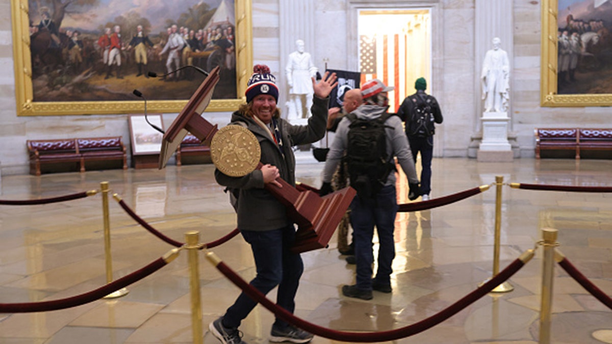 The man seen carrying the U.S. House lectern has reportedly been identified on social media. (Photo by Win McNamee/Getty Images)