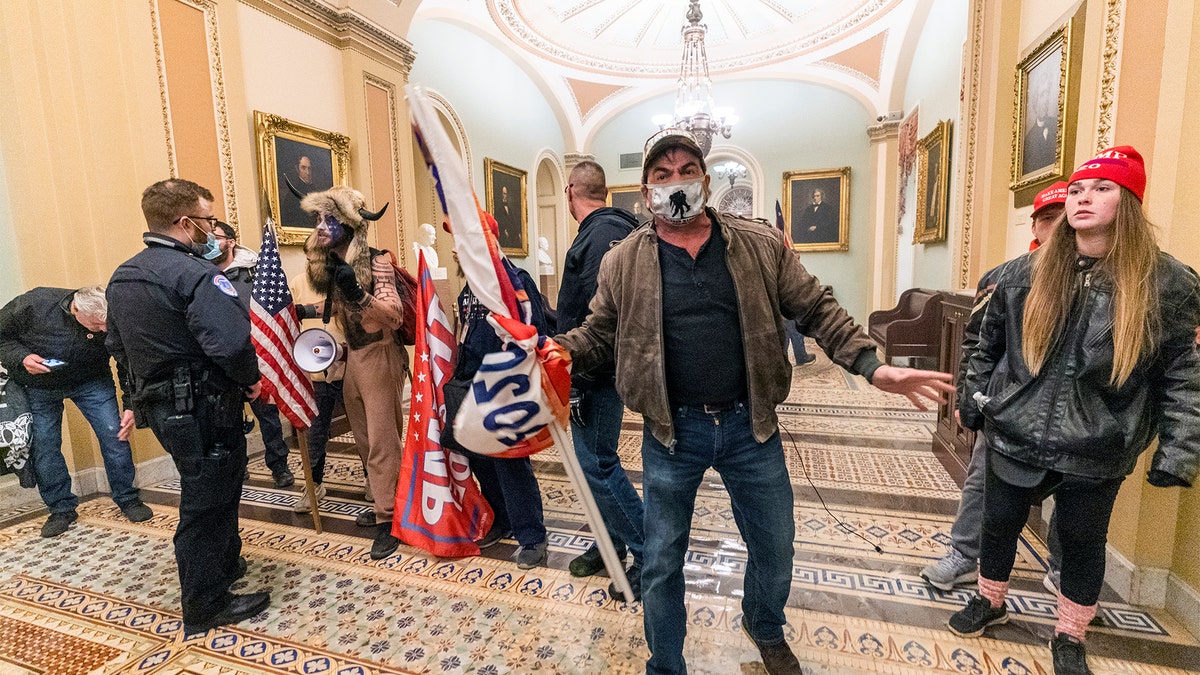 Supporters of President Trump are confronted by U.S. Capitol Police officers outside the Senate Chamber inside the Capitol, Wednesday, Jan. 6, 2021 in Washington.