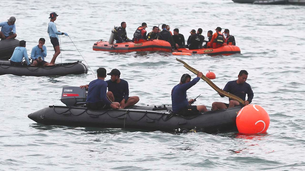 Rescuers carry debris found in the waters around the location where a Sriwijaya Air passenger jet has lost contact with air traffic controllers shortly after the takeoff, in Java Sea, near Jakarta, Indonesia, Sunday, Jan. 10, 2021. (Associated Press)