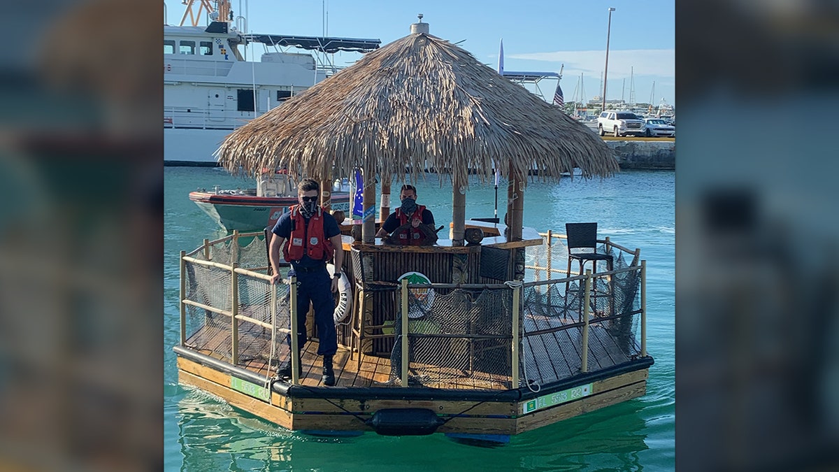 Photos show USCG members at the "helm" of the floating bar and on deck as they brough it back to harbor.