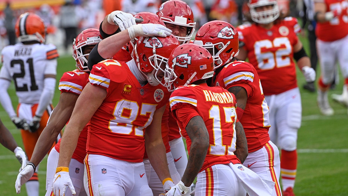 Kansas City Chiefs tight end Travis Kelce (87) celebrates with teammates after scoring on a 20-yard touchdown reception during the first half of an NFL divisional round football game against the Cleveland Browns, Sunday, Jan. 17, 2021, in Kansas City. (AP Photo/Reed Hoffmann)