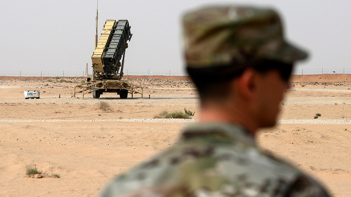 FILE - In this Feb. 20, 2020 file photo, a member of the U.S. Air Force stands near a Patriot missile battery at the Prince Sultan Air Base in al-Kharj, Saudi Arabia. (Andrew Caballero-Reynolds/Pool via AP, File)