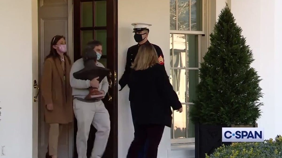 A bust of Abe Lincoln is carried out of the White House grounds. (C-SPAN)