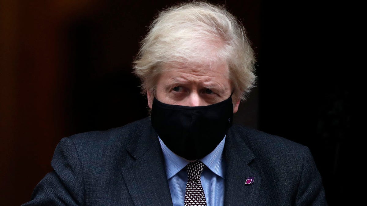 Johnson leaves 10 Downing Street for the House of Commons for the weekly Prime Ministers Questions in London, Wednesday, Jan. 27, 2021. (AP Photo/Alastair Grant)