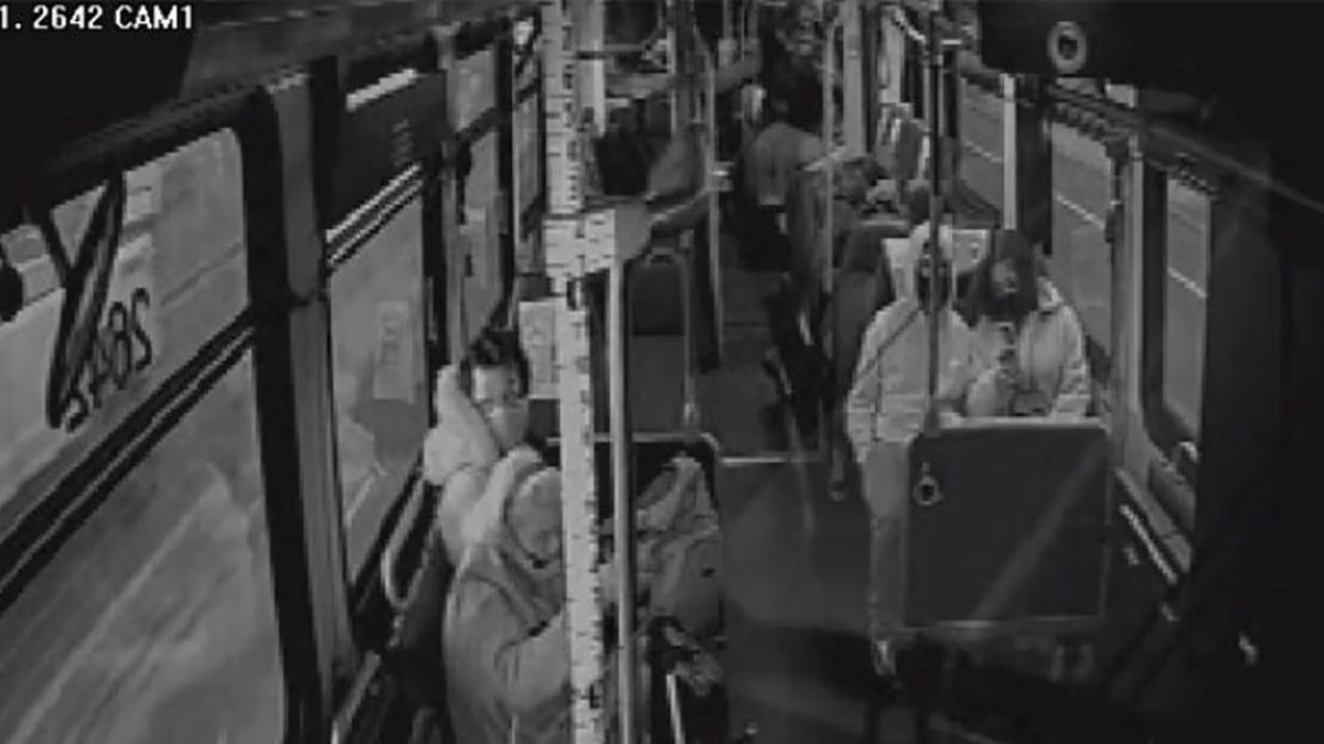 This still image taken from surveillance video aboard a Metro bus shows a man kicking a woman in the side of her head.