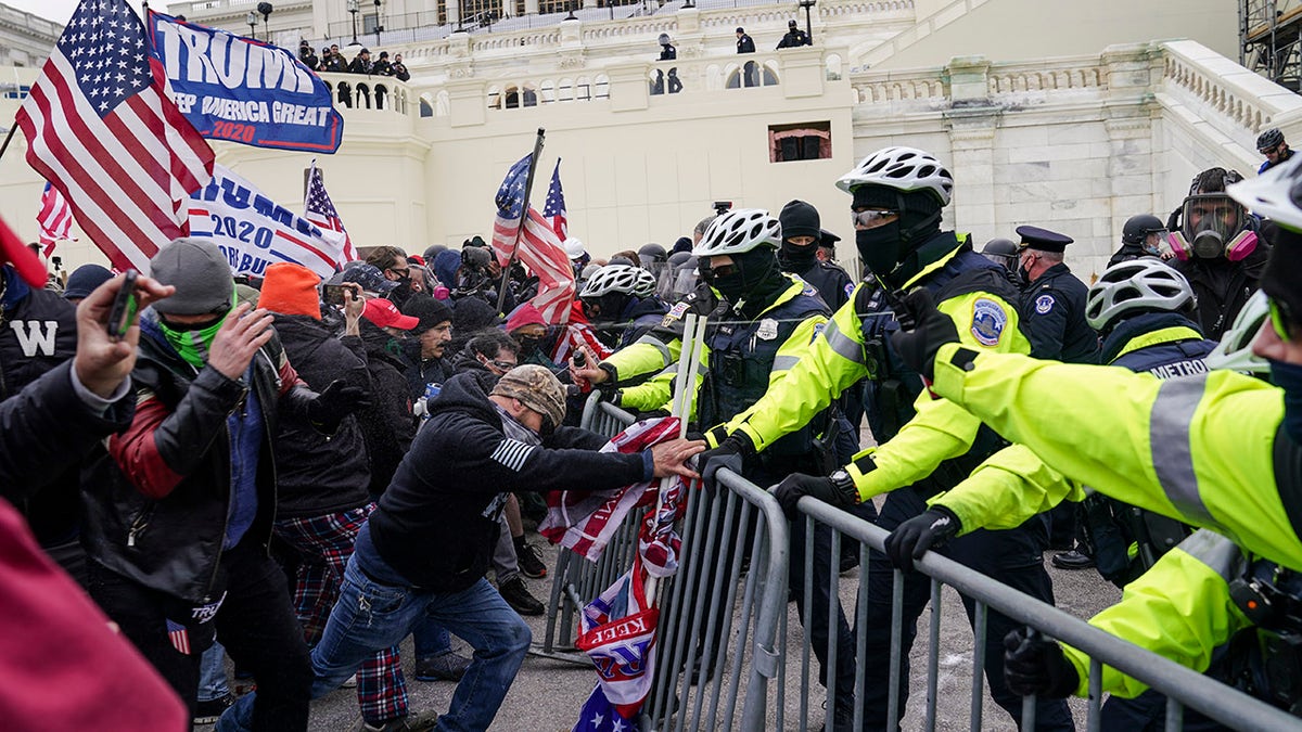 Trump supporters try to break through a police barrier, Wednesday, Jan. 6, 2021, at the Capitol in Washington. The pro-Trump mob eventually stormed the Capitol, with some chanting ‘hang Mike Pence," forcing Pence and hundreds of lawmakers into hiding. (AP Photo/John Minchillo)
