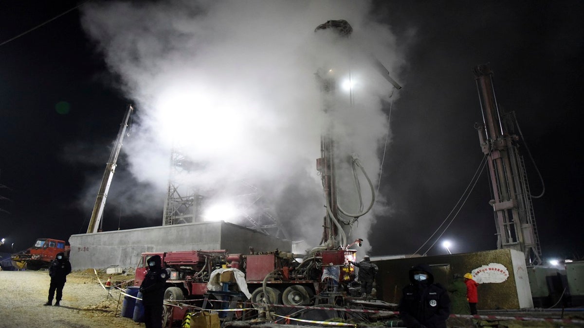 Chinese state media say 12 out of 22 workers trapped for a week by an explosion in the gold mine are alive, as hundreds of rescuers seek to bring them to safety. (AP/Xinhua)