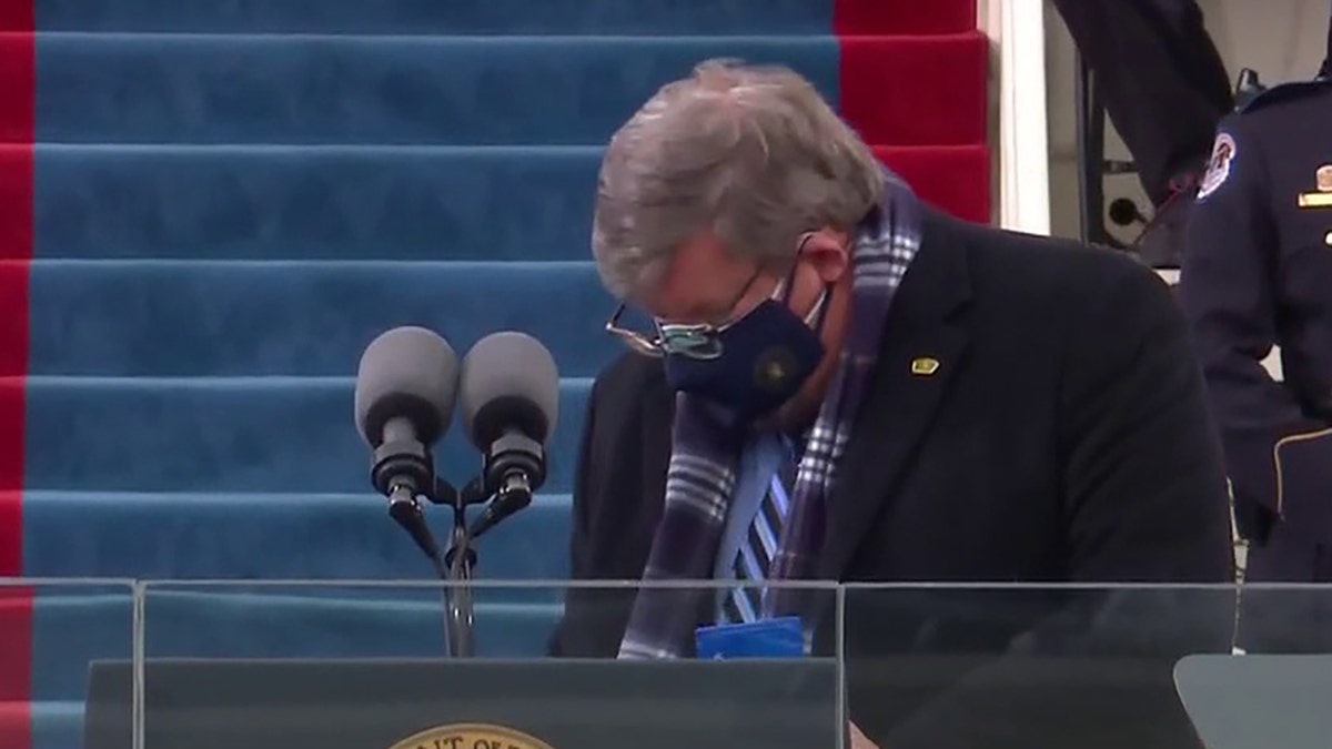 The unidentified podium sanitizer wipes away Wednesday during Joe Biden's presidential inauguration. (Fox News video image)