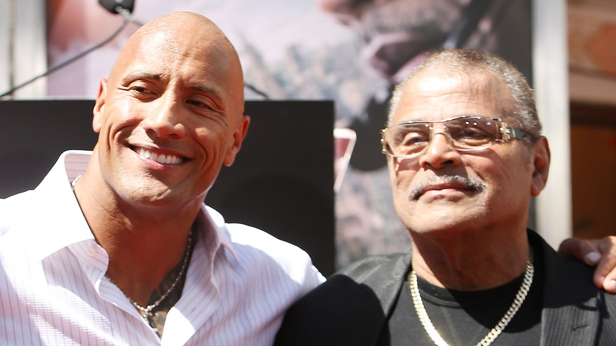 Dwayne "The Rock" Johnson, left, said he had an "incredibly complicated" relationship with his father, WWE star Rocky Johnson. (Photo by Michael Tran/FilmMagic)