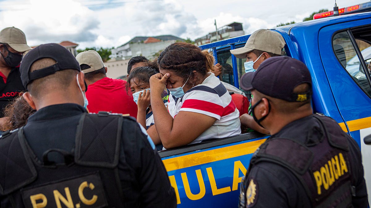 A Honduran migrant woman trying to reach the U.S. cries after she was detained in the Guatemalan department of Chiquimula, Tuesday, Jan. 19, 2021. (AP Photo/Oliver de Ros)