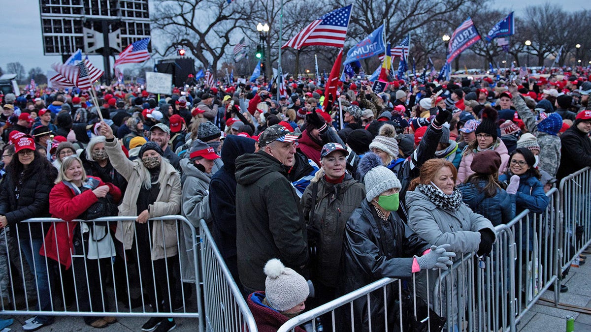 People wait for a rally of supporters of President Donald Trump challenging the results of the 2020 U.S. presidential election on the Ellipse outside of the White House on January 6, 2021, in Washington, DC. (Photo by Brendan Smialowski/AFP via Getty Images)