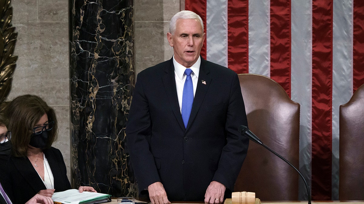 Vice President Mike Pence listens after reading the final certification of Electoral College votes cast in November's presidential election during a joint session of Congress after working through the night, at the Capitol in Washington, Thursday, Jan. 7, 2021. Violent protesters loyal to President Donald Trump stormed the Capitol Wednesday, disrupting the process. (AP Photo/J. Scott Applewhite, Pool)