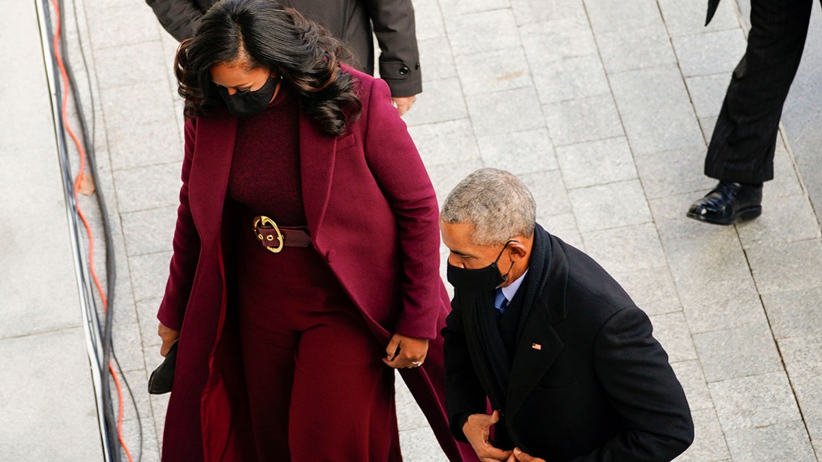 The former first lady wore a purple, almost burgundy overcoat by Black American designer Sergio Hudson for Wednesday's event, completed with a matching belt cinched at her waist with a gold circle buckle.