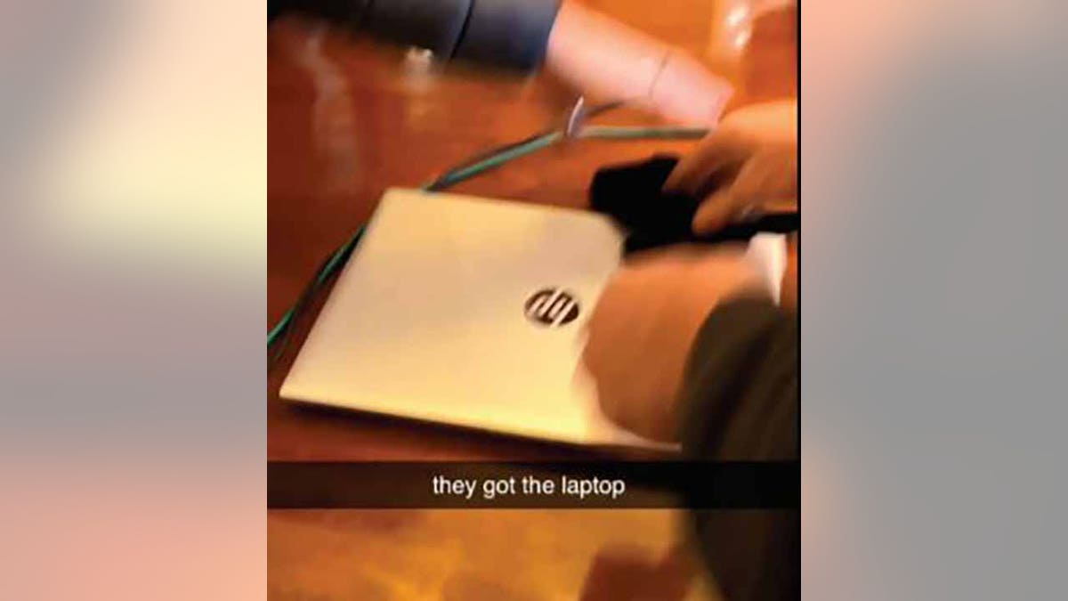 Another video allegedly recorded by Williams showed the Hewlett-Packard laptop on a wooden desk. (Justice Department)