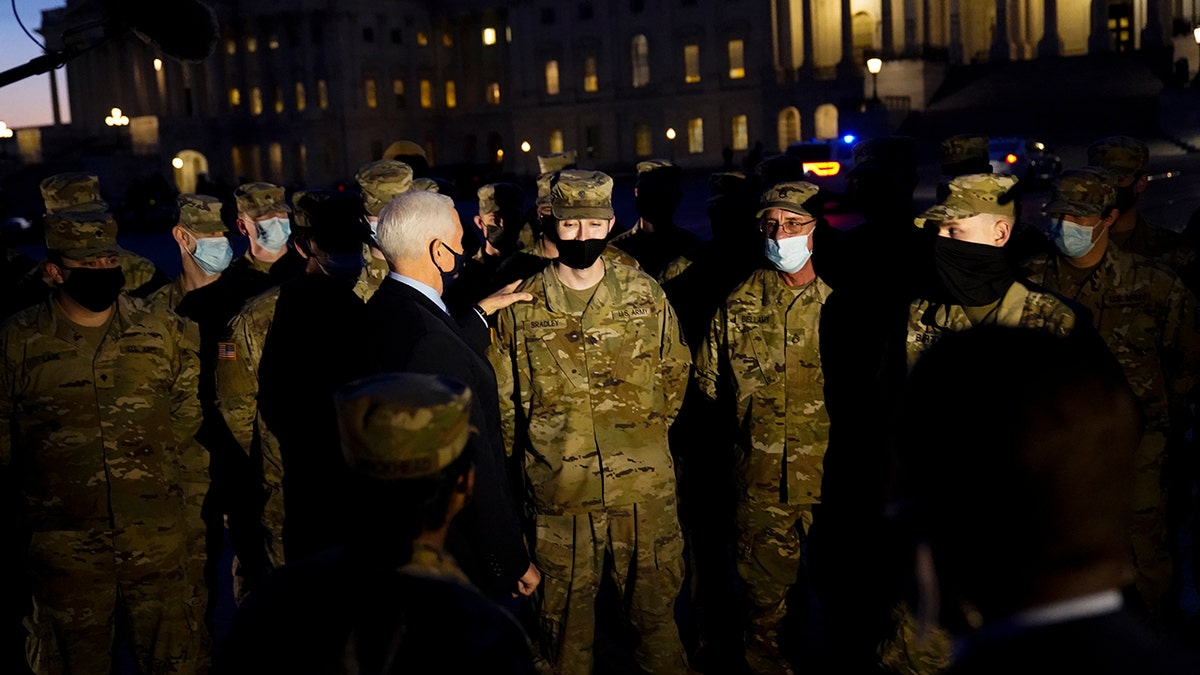 Vice President Mike Pence speaks to National Guard troops outside the U.S. Capitol, Thursday, Jan. 14, 2021, in Washington. (AP Photo/Alex Brandon, Pool)