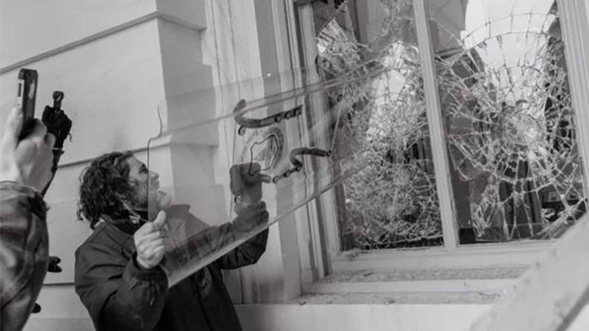 Pezzola seen using a stolen police riot shied to smash a window at the U.S. Capitol on Jan. 6. (Justice Department)