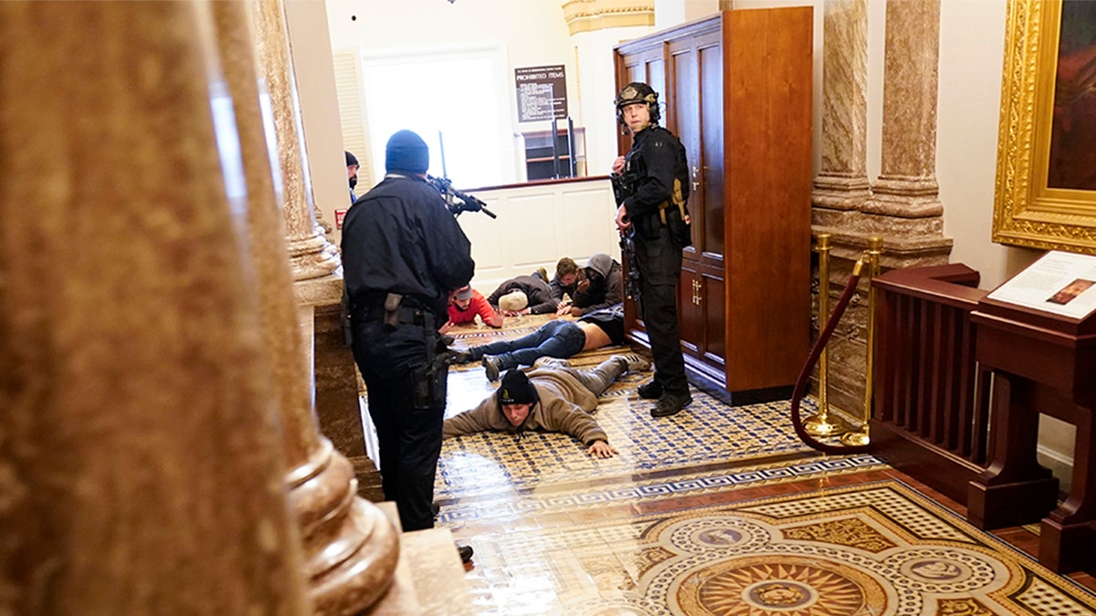 U.S. Capitol Police hold protesters at gunpoint near the House Chamber inside the U.S. Capitol on Wednesday, Jan. 6, 2021, in Washington.