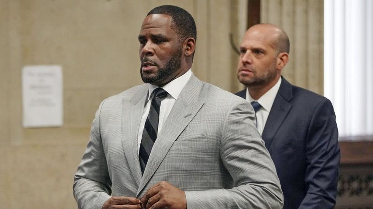R. Kelly in a gray suit