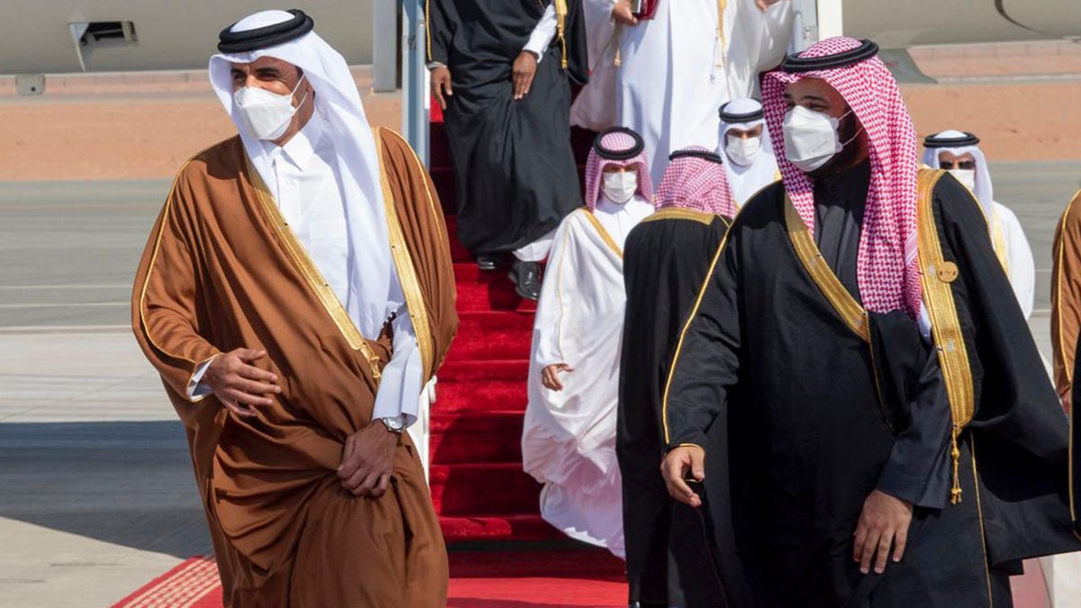 Saudi Arabia's Crown Prince Mohammed bin Salman, right, welcomes Qatar's Emir Sheikh Tamim bin Hamad al-Thani upon his arrival to attend the Gulf Cooperation Council's 41st Summit in Al-Ula, Saudi Arabia, Tuesday, Jan. 5, 2021. (Saudi Royal Court via AP)