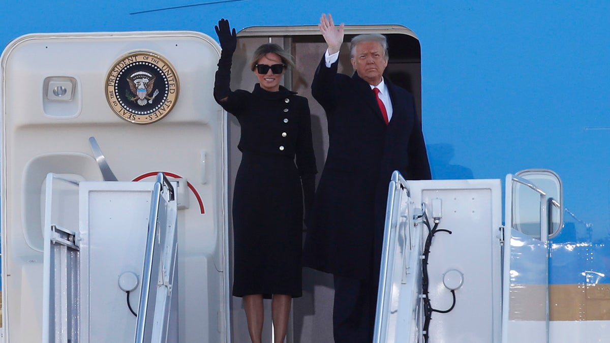 President Donald Trump and first lady Melania Trump wave to a crowd as they board Air Force One at Andrews Air Force Base, Md., Wednesday, Jan. 20, 2021. (AP Photo/Luis M. Alvarez)