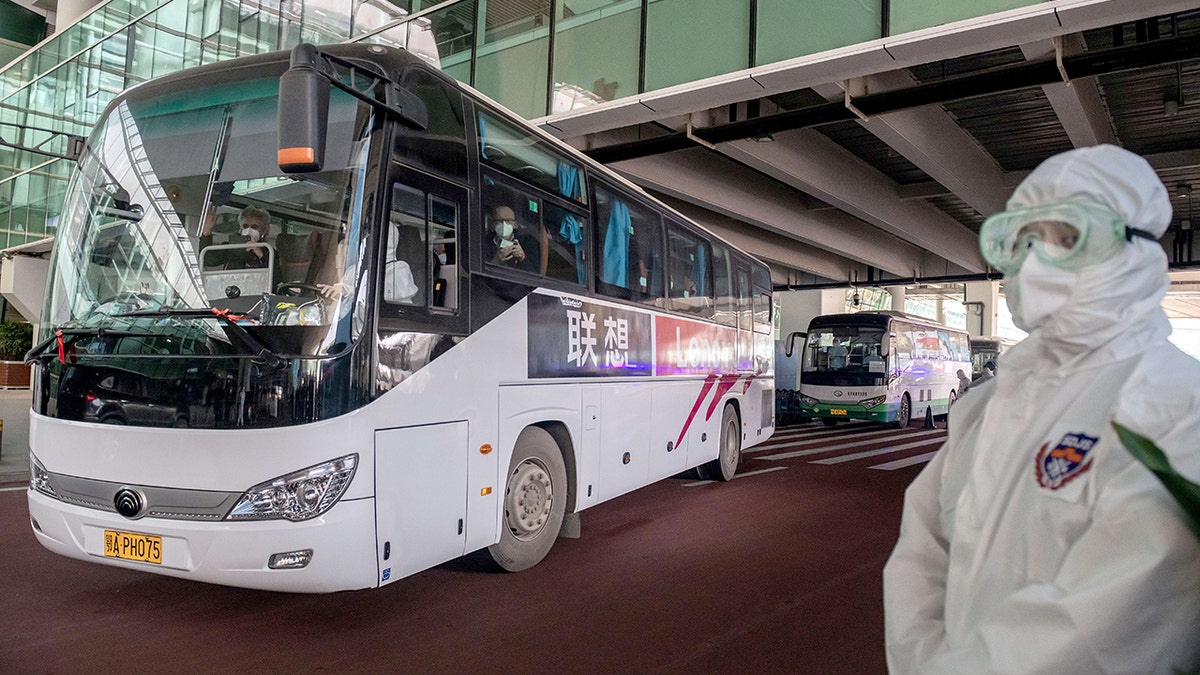 A bus carrying members of the World Health Organization (WHO) team investigating the origins of the Covid-19 pandemic leaves the airport following their arrival at a cordoned-off section in the international arrivals area at the airport in Wuhan on January 14, 2021. (Photo by NICOLAS ASFOURI / AFP) (Photo by NICOLAS ASFOURI/AFP via Getty Images)