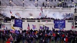 In this Wednesday, Jan. 6, 2021, file photo, violent protesters, loyal to President Donald Trump, storm the Capitol, in Washington. A Massachusetts teenager publicly called out her relatives after recognizing them as possible rioters during last week’s riot in Washington D.C.. (AP Photo/John Minchillo, File)